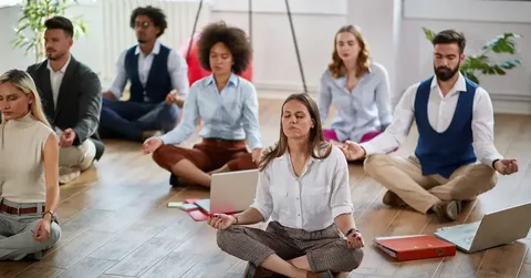 Employees participating in a corporate stress management workshop to improve wellness and productivity